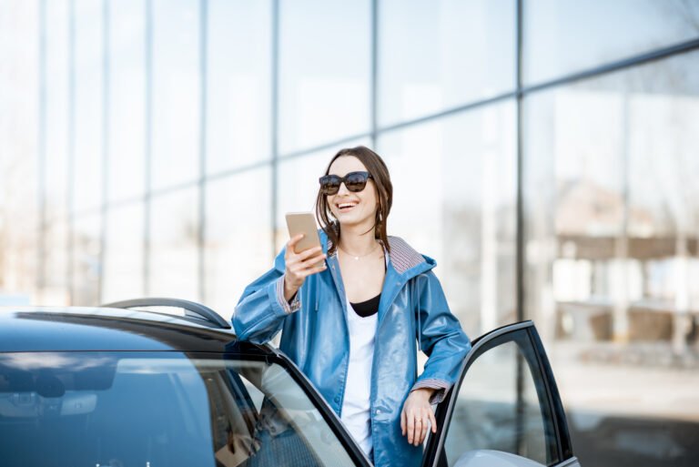 woman-with-smart-phone-near-the-car-outdoors-2023-11-27-04-51-33-utc